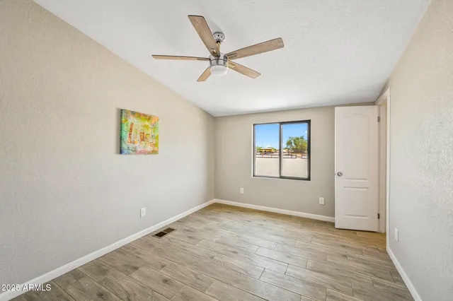 a view of a patio with a table and chairs under an umbrella