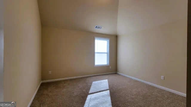 a view of a livingroom with a ceiling fan and window
