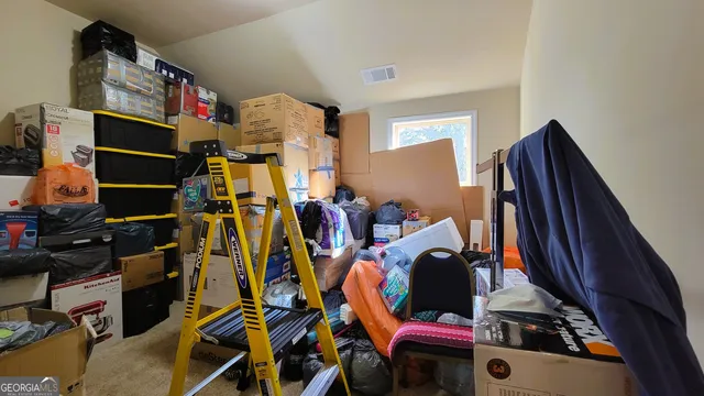 an empty room with ceiling fan and window