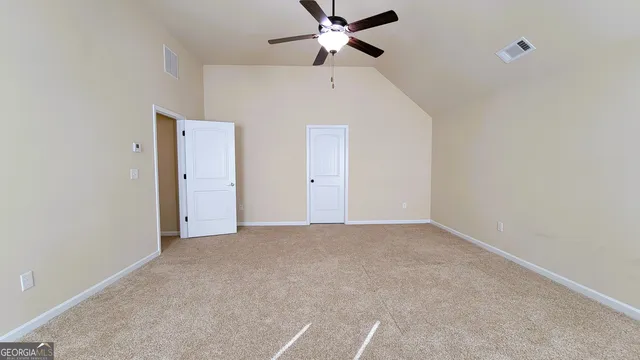 a view of a livingroom with a ceiling fan and window