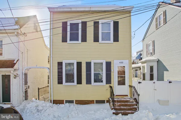 a front view of a house with a chair