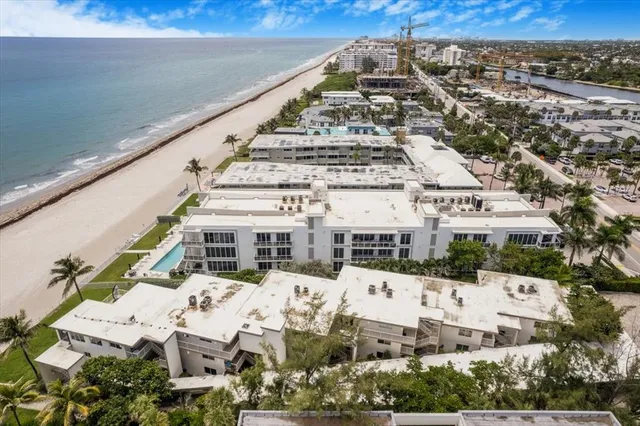 a view of buildings with yard and ocean view