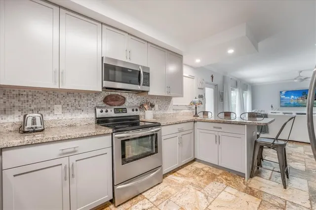 a kitchen with granite countertop cabinets stainless steel appliances and a sink