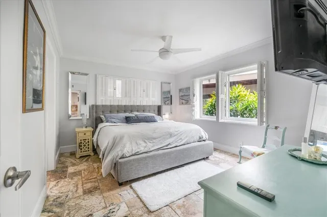 a bedroom with a large bed and a window