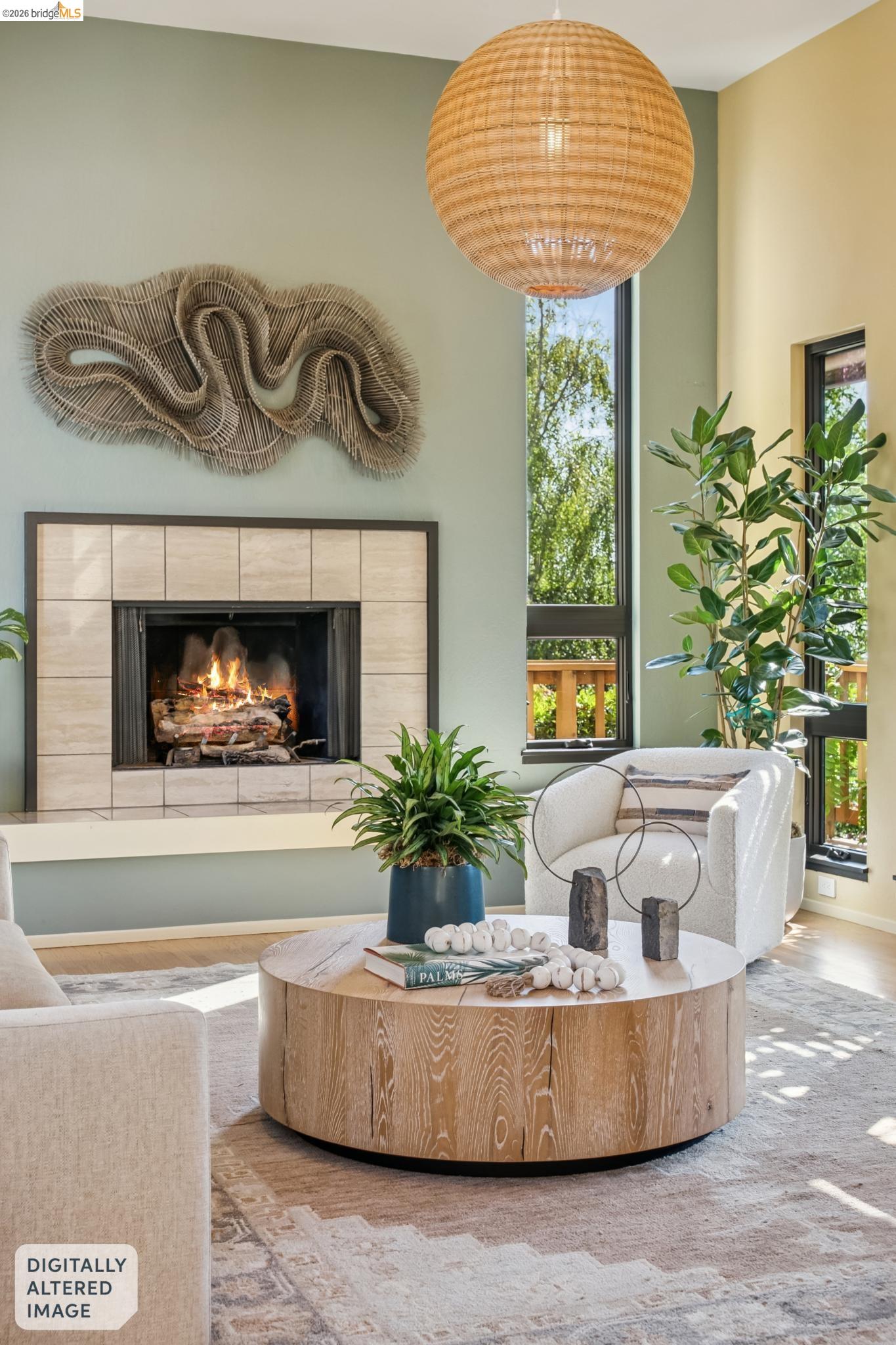 576 Vistamont Avenue Berkeley, CA 94708 - Photo 19 of 33 Living area featuring a tiled fireplace with a dark surround, a large rattan pendant light fixture, and tall black-framed windows