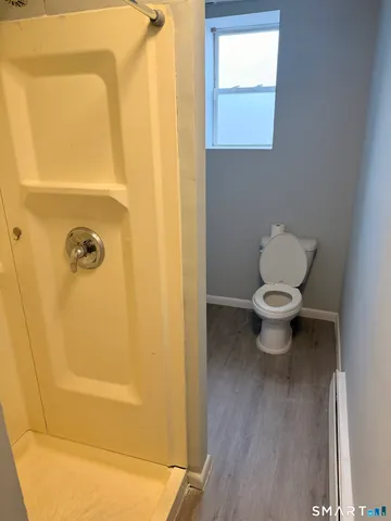 a bathroom with a toilet and a shower
