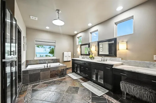 a large kitchen with kitchen island a sink stainless steel appliances and cabinets