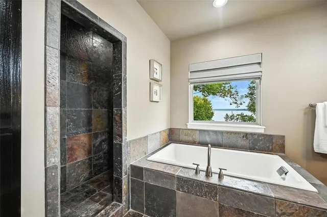 a bathroom with a tub and shower
