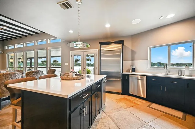 a kitchen with granite countertop a sink and cabinets