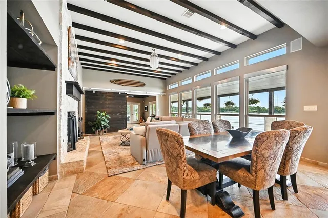 a dining room with furniture a rug and a potted plant