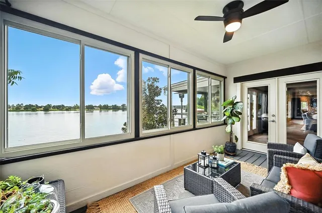 a living room with furniture and a floor to ceiling window