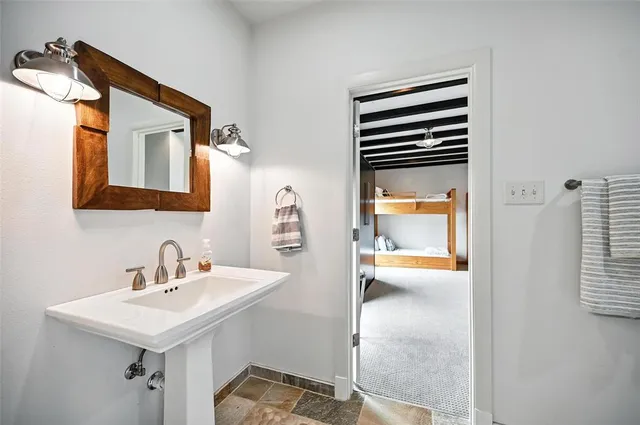a bathroom with a sink a mirror and a bathtub