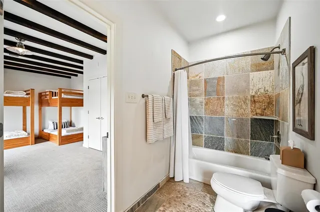 a bathroom with a toilet a sink and a bathtub