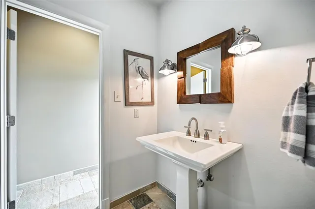 a bathroom with a sink and a mirror
