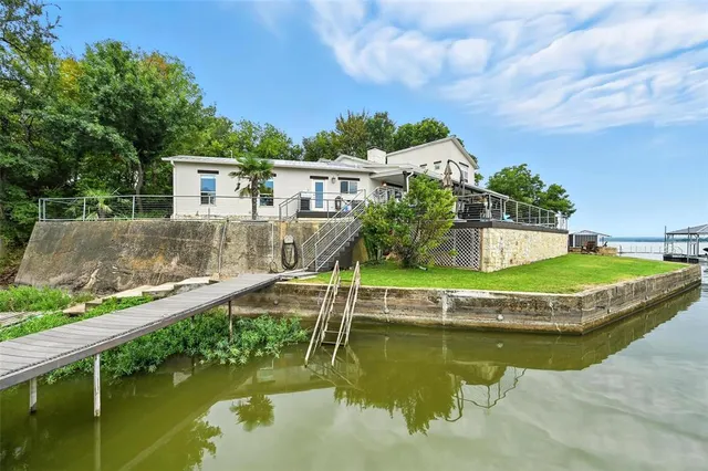 a view of a house with swimming pool and a yard