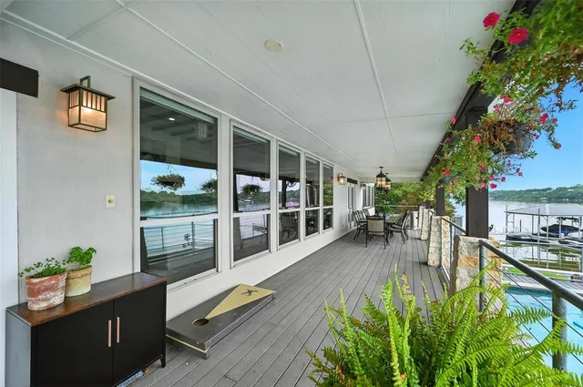 a swimming pool with outdoor seating and plants