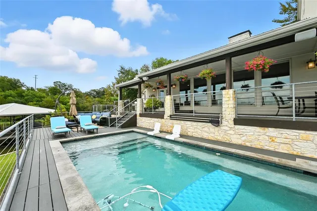 a view of a house with swimming pool and sitting area