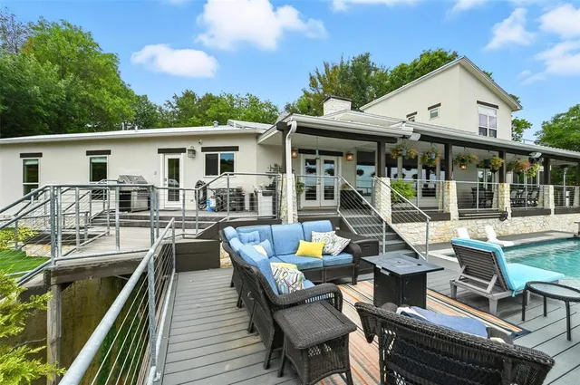 a view of a patio with dining table and chairs with wooden floor
