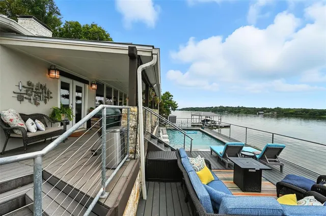 a view of a balcony with two chairs and a wooden floor
