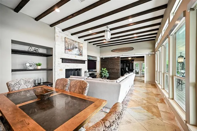 a living room with fireplace furniture and a large window