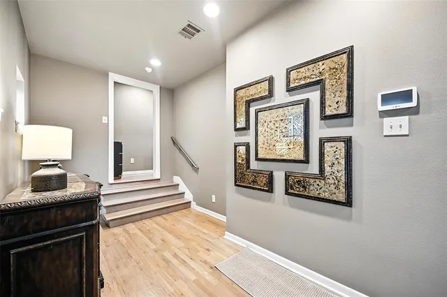 a view of a hallway with furniture and stairs