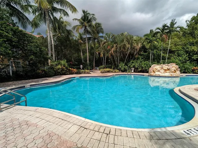 a view of a swimming pool with a yard