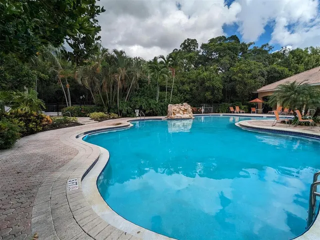 a view of a house with pool yard and patio