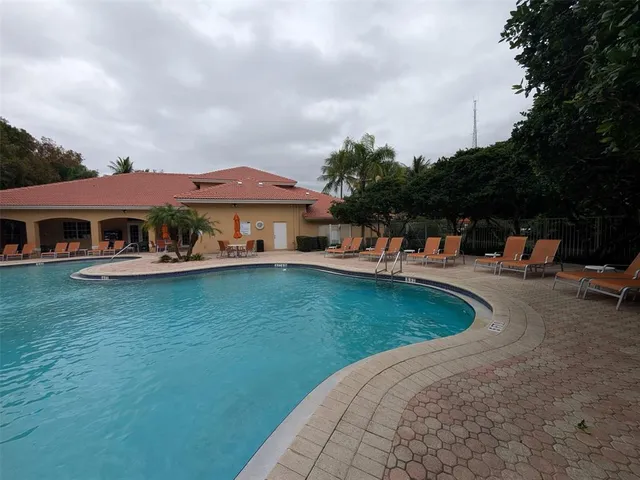 a view of a swimming pool with a yard