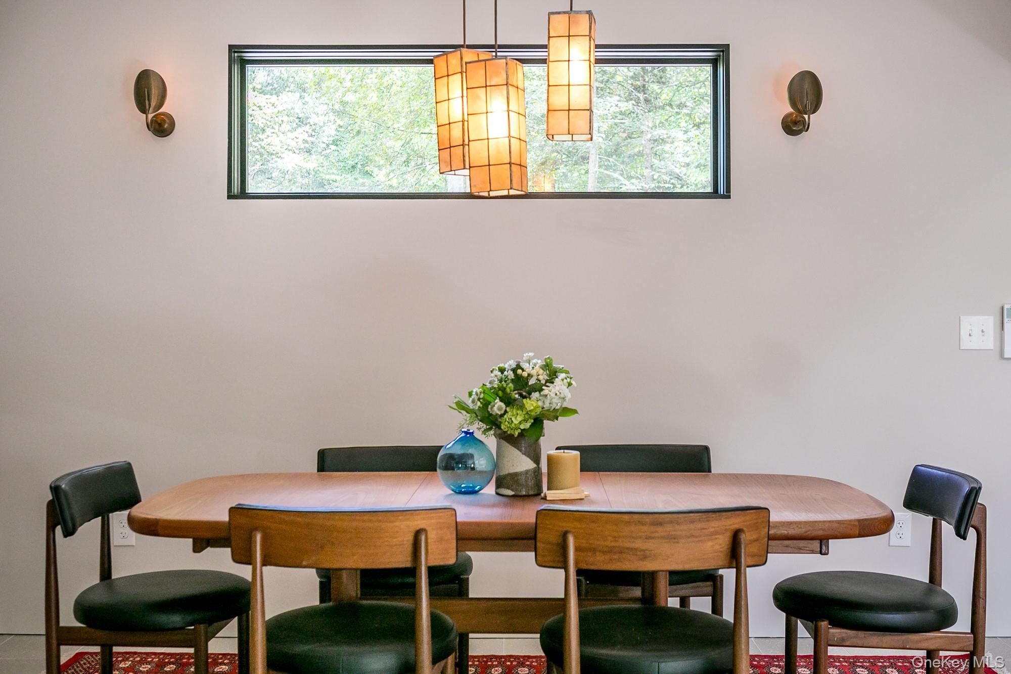 35 Fern Hollow Road Stone Ridge, NY 12484 - Photo 13 of 40 a view of a dining room with furniture and a potted plant