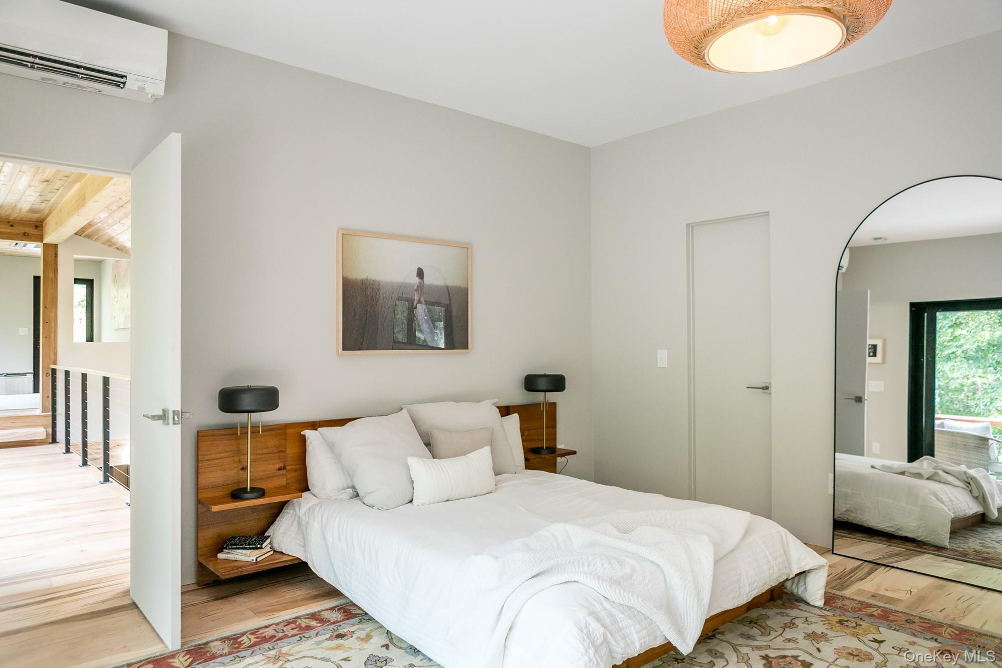 35 Fern Hollow Road Stone Ridge, NY 12484 - Photo 23 of 40 a bedroom with a bed and a lamp