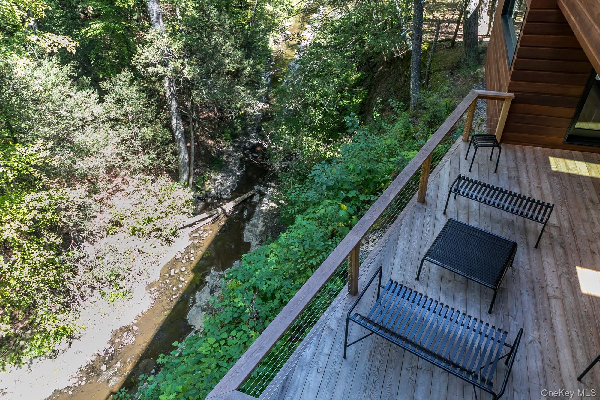 35 Fern Hollow Road Stone Ridge, NY 12484 - Photo 30 of 40 a balcony with wooden floor and trees in the back