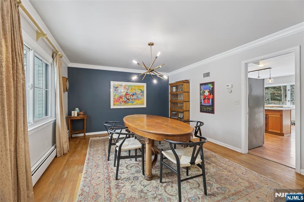 320 Park Street Haworth, NJ 07641 - Photo 17 of 48 a dining room with furniture a chandelier and wooden floor