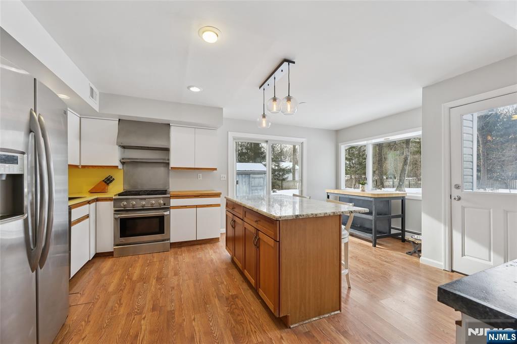 320 Park Street Haworth, NJ 07641 - Photo 19 of 48 a large kitchen with a center island and stainless steel appliances