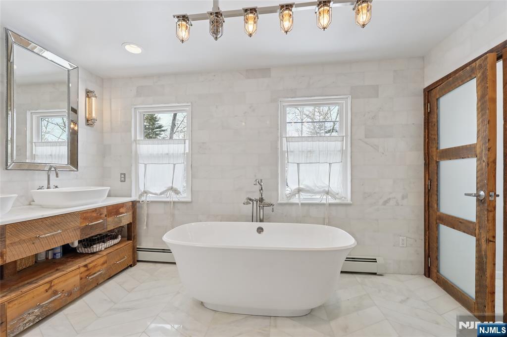 320 Park Street Haworth, NJ 07641 - Photo 31 of 48 a white bath tub sitting next to a bathroom sink