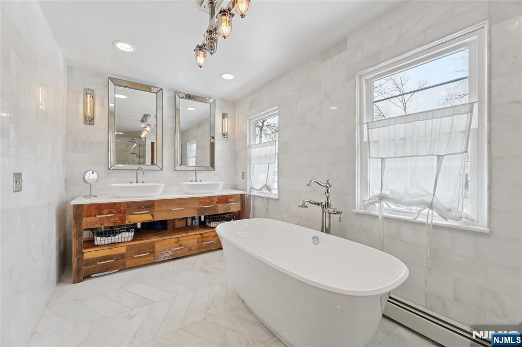 320 Park Street Haworth, NJ 07641 - Photo 33 of 48 a bathroom with a tub a sink and mirror