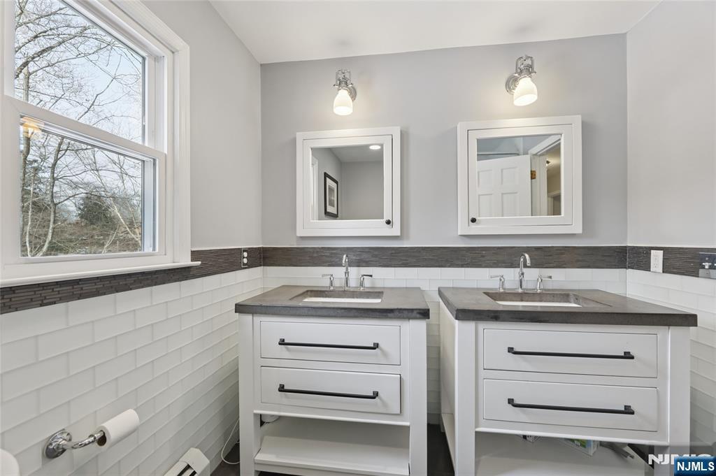 320 Park Street Haworth, NJ 07641 - Photo 39 of 48 a bathroom with a granite countertop sink vanity and mirror