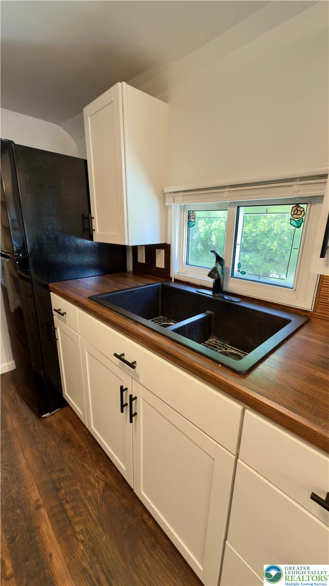 246 Poplar Street Bath, PA 18014 - Photo 20 of 34 A well-appointed kitchen features rich wood countertops and modern white cabinetry, creating a stylish workspace.