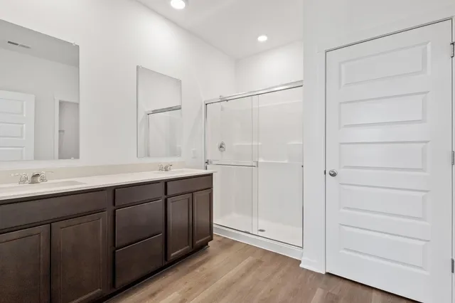 a bathroom with a double vanity sink and mirror