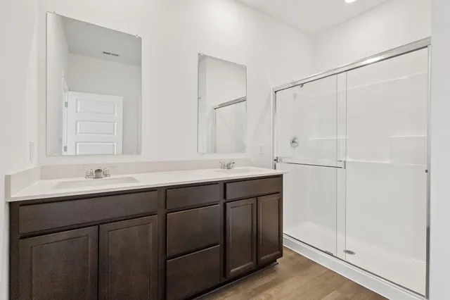 a bathroom with a double vanity sink and mirror