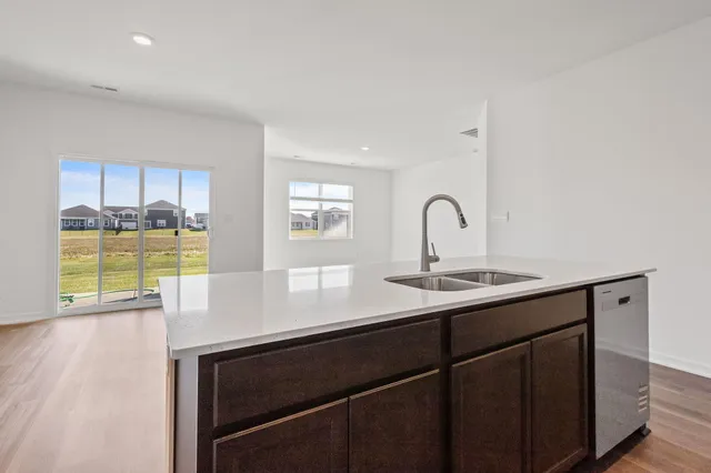 a kitchen with a sink cabinets and a wooden floor