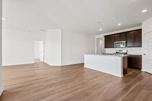 a view of kitchen with microwave and cabinets