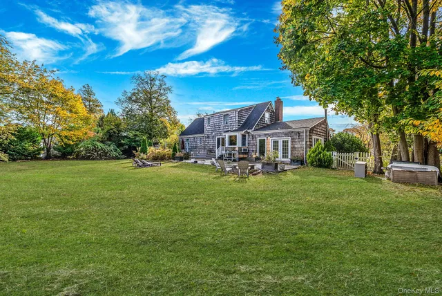 a backyard of a house with table and chairs
