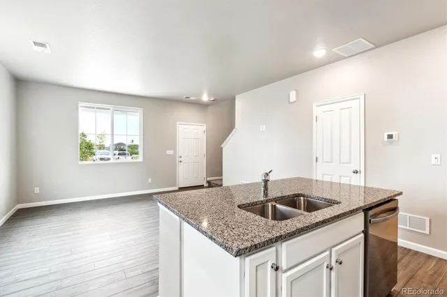 a kitchen with granite countertop a sink and a window
