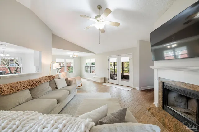 a living room with furniture a fireplace and a flat screen tv