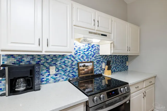 a view of a dining room with furniture a chandelier and wooden floor