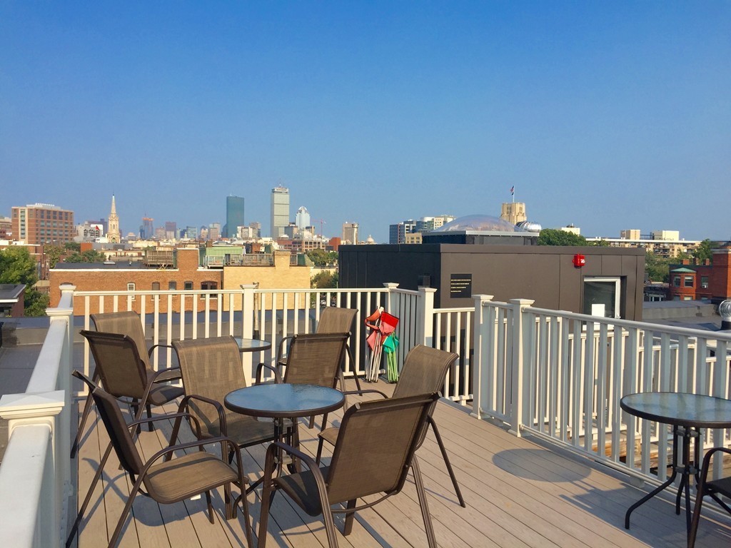 1056 Beacon Street, Unit 15 Brookline, MA 02446 - Photo 3 of 9 a view of a balcony with chairs