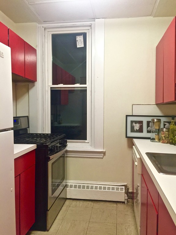 1056 Beacon Street, Unit 15 Brookline, MA 02446 - Photo 8 of 9 a kitchen with a stove and a sink
