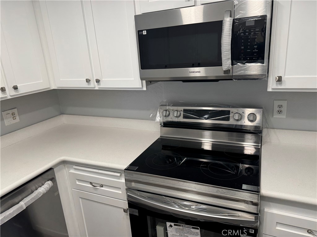 13602 La Jolla Circle, Unit B La Mirada, CA 90638 - Photo 13 of 27 a kitchen with microwave and cabinets
