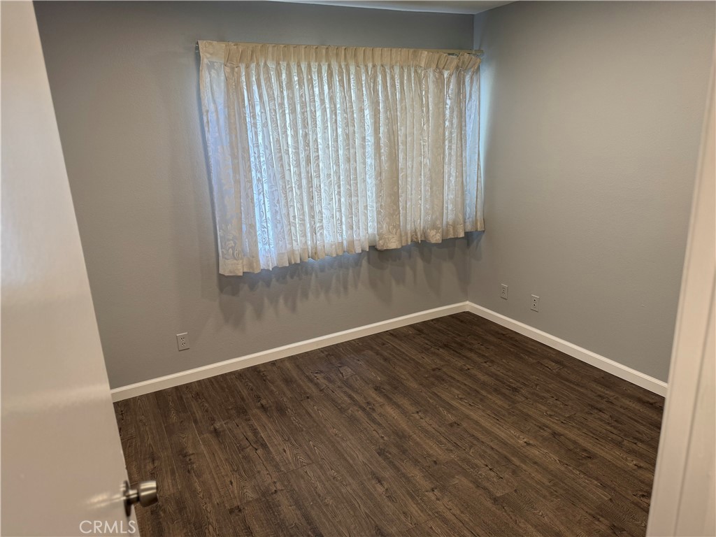 13602 La Jolla Circle, Unit B La Mirada, CA 90638 - Photo 16 of 27 an empty room with wooden floor and windows
