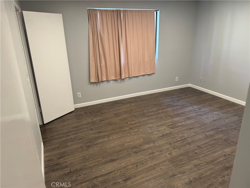 13602 La Jolla Circle, Unit B La Mirada, CA 90638 - Photo 17 of 27 an empty room with wooden floor and windows